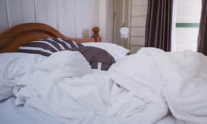 Bed covered with bedding - dust mites
